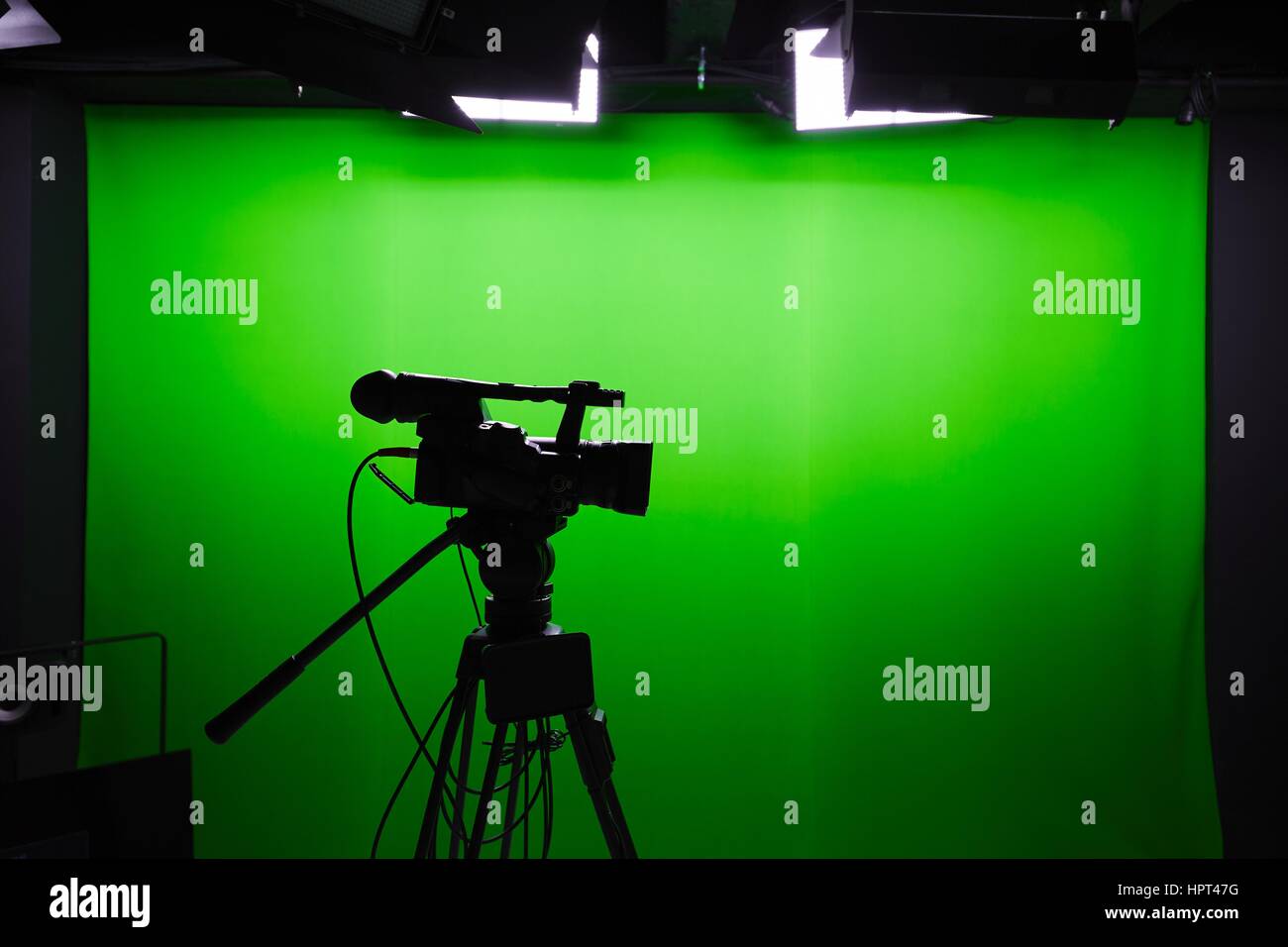 Silhouette of digital video camera in front of the green screen Stock Photo  - Alamy