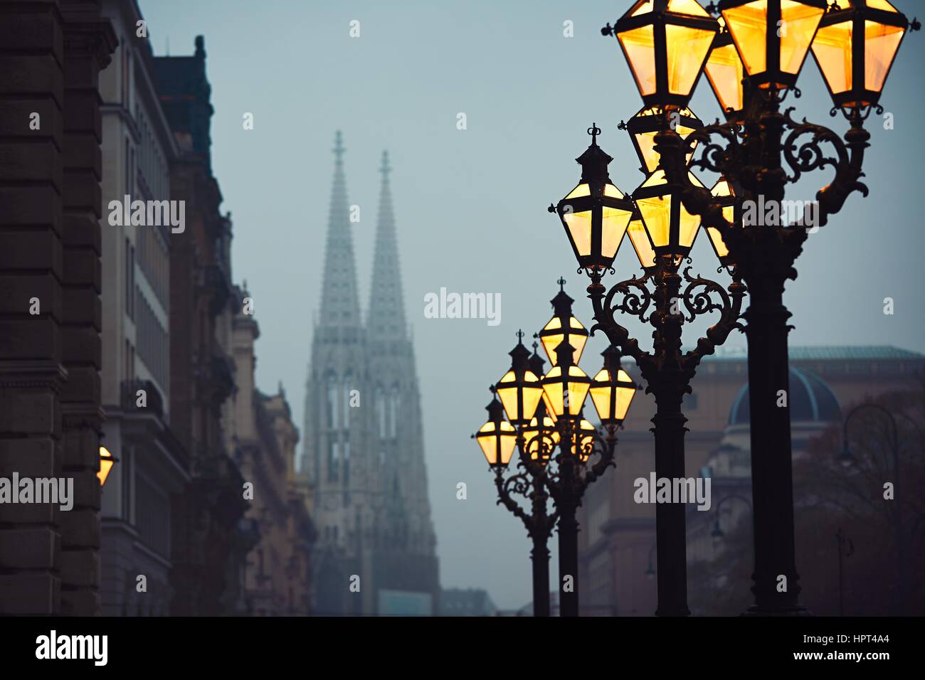 Street lamps and Votive Church during chilly autumn evening in Vienna, Austria - selective focus Stock Photo