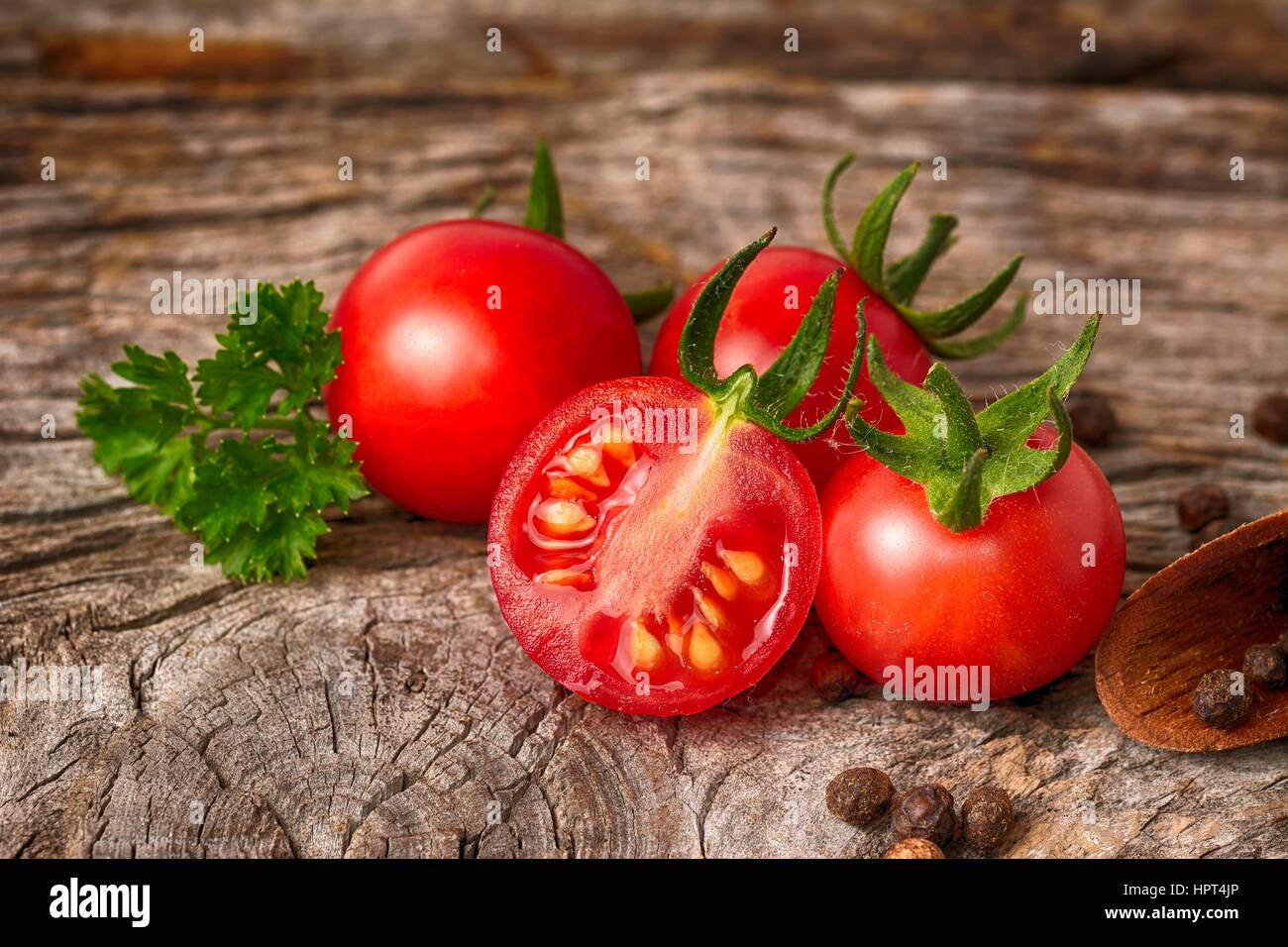 Close-up of fresh, ripe cherry tomatoes on wood Stock Photo - Alamy