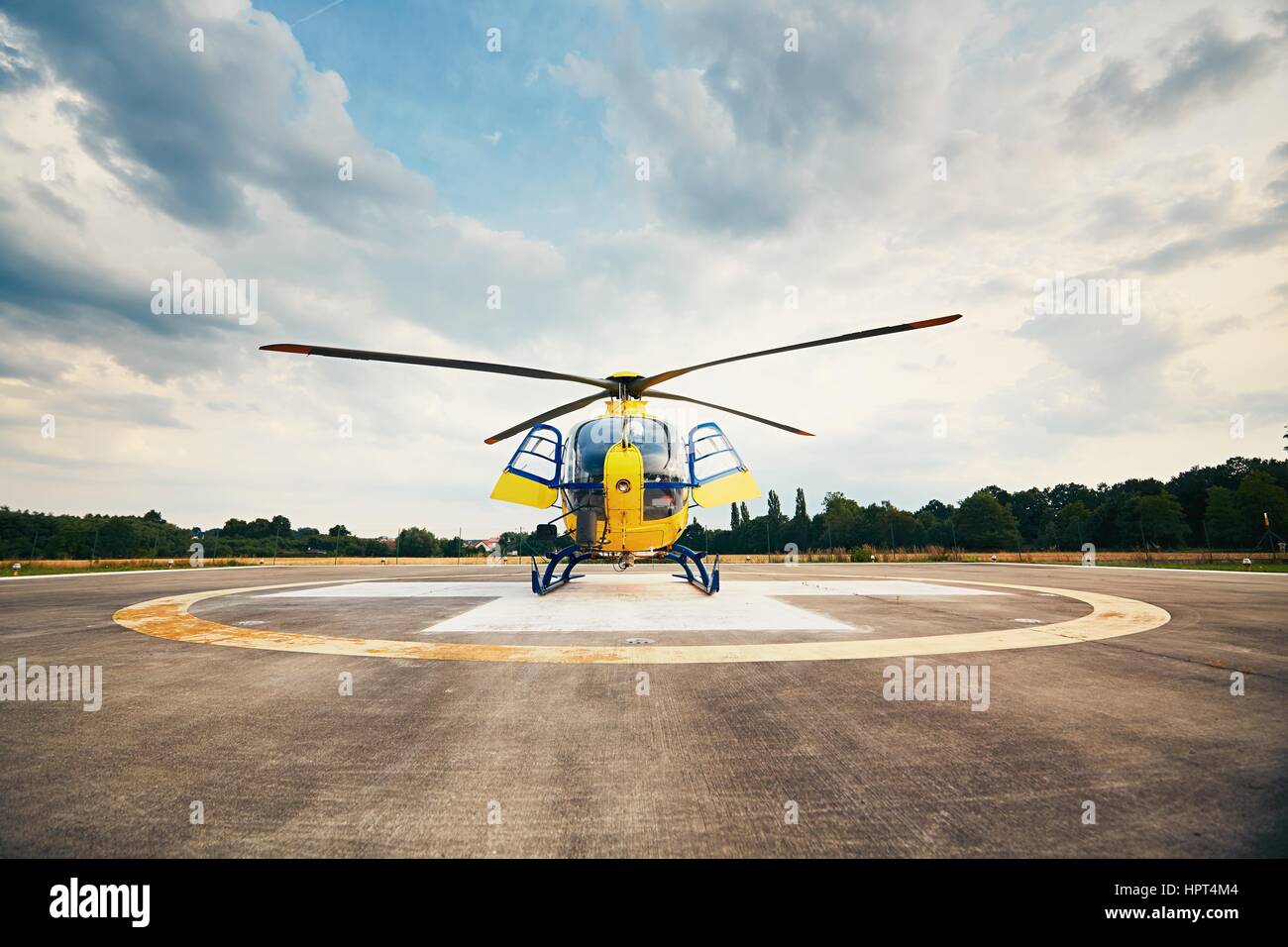 Air rescue service. Helicopter air ambulance is ready for take off at the heliport. Stock Photo
