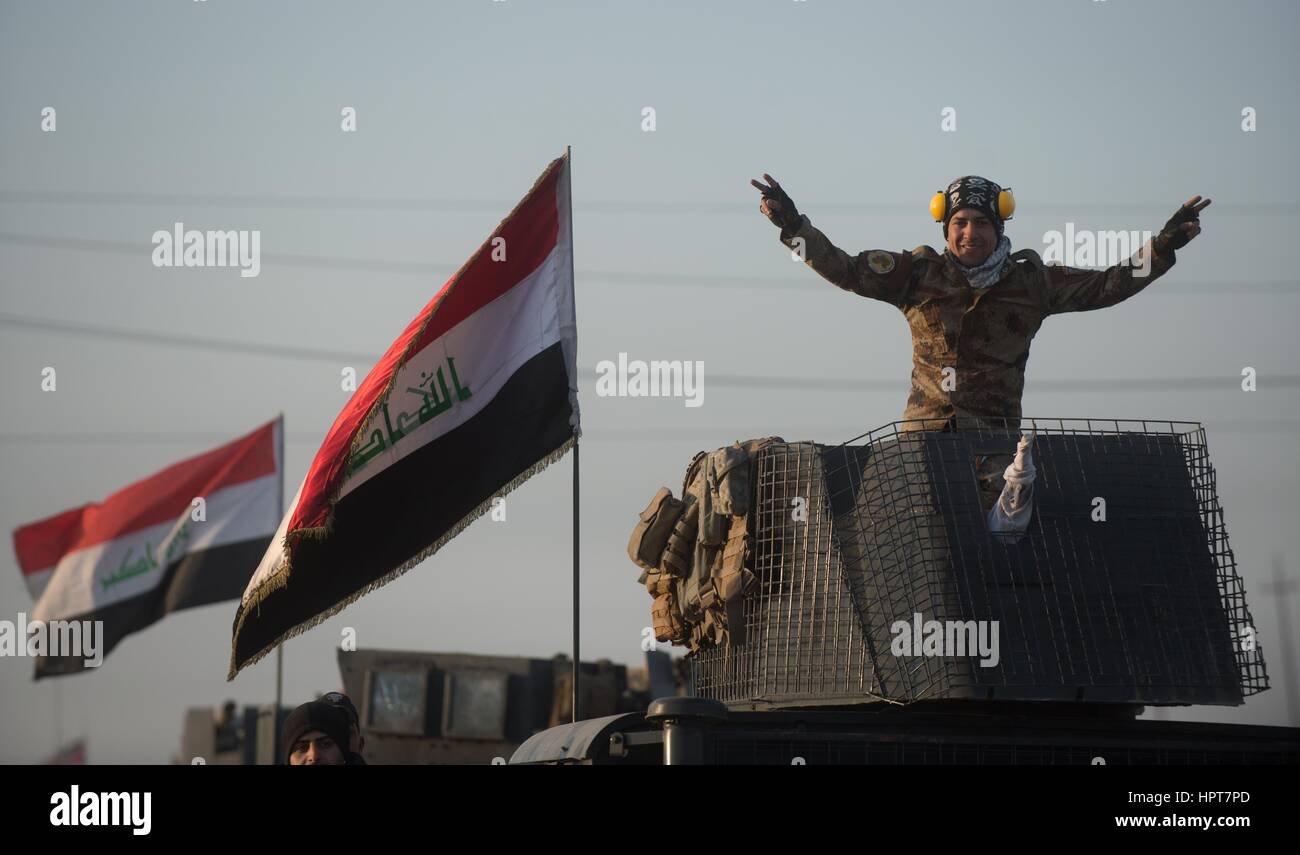 Mosul, Iraq. 23rd Feb, 2017. Iraqi Special Forces soldiers wave from a convoy heading to the frontline as the Iraq government continues to capture territory from ISIS February 23, 2017 in Mosul, Iraq. Iraqi forces moved into western Mosul taking full control of the international airport on the southwestern edge of the city. Credit: Planetpix/Alamy Live News Stock Photo