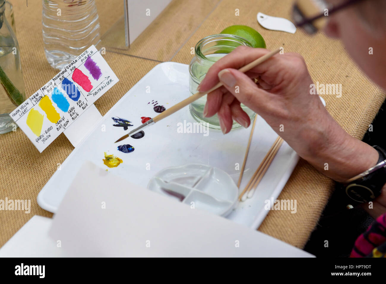 London, UK. 24th Feb, 2017. An visitor joins a painting demonstration as members of the public view the work of some of the world's best botanical artists through a display of previously unseen work at the RHS London Botanical Art Show. Taking place this weekend, the show features artists from the UK and internationally including USA, Italy, Japan, New Zealand and South Korea. Credit: Stephen Chung/Alamy Live News Stock Photo