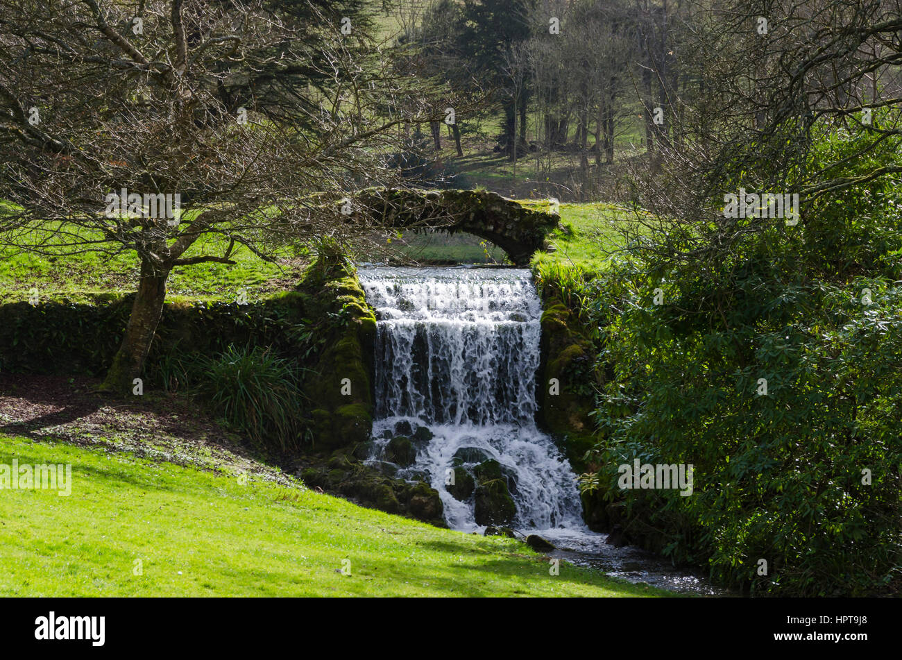 Littlebredy, Dorset, UK. 24th Feb, 2017. UK Weather. Glorious afternoon sunshine at Bridehead House Garden waterfall at Littlebredy in Dorset. Bridehead House Gardens at Littlebredy is the fictional location of Axehampton House which features in series 3 of the ITV hit series Broadchurch which returns to our screens on Monday 27th February. Credit: Graham Hunt/Alamy Live News Stock Photo