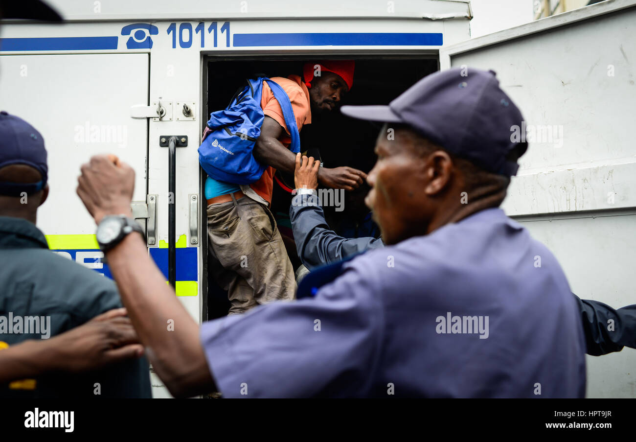 Pretoria, South Africa. 24th Feb, 2017. An arrested activist is put into a police vehicle during an anti-immigrant march in Pretoria, South Africa, on Feb. 24, 2017. Police arrested 136 people in Pretoria West over the past 24 hours, including during an anti-immigrant march in Pretoria, South African Police Service Acting National Commissioner Khomotso Phahlane said on Friday. Credit: Zhai Jianlan/Xinhua/Alamy Live News Stock Photo