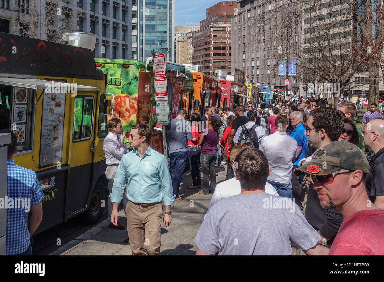 Washington, DC, USA. 24th February, 2017. For second day in a row with temperatures in upper 70's (F), lunchtime crowd lines up at food trucks at Farragut Square, enjoying what meteorologists are saying will be the warmest February on record. Credit: Bob Korn/Alamy Live News Stock Photo