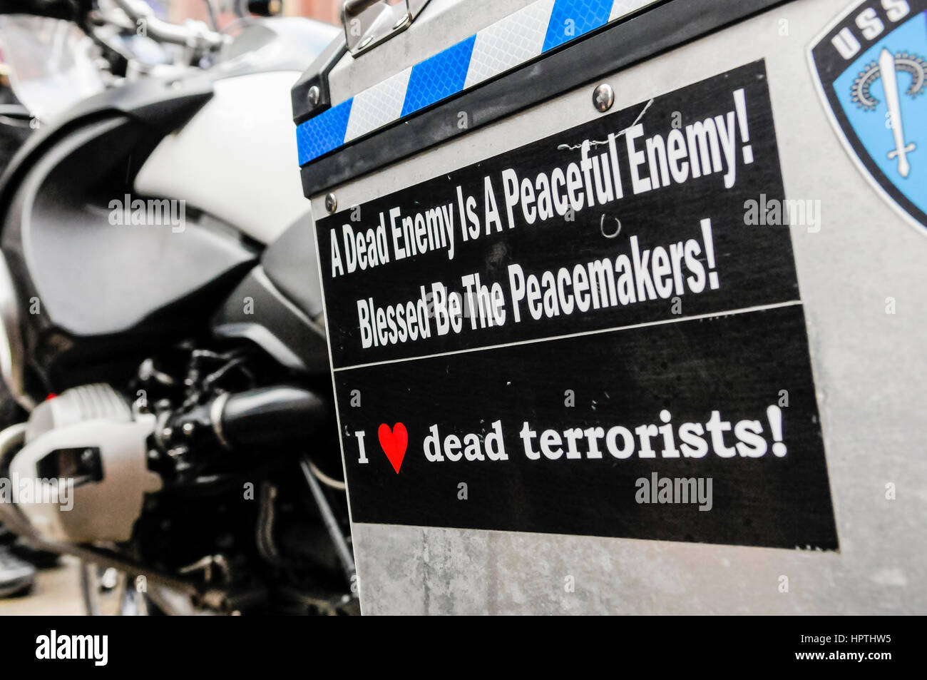 Belfast, Northern Ireland. 25 Feb 2017 - A motorcycle pannier with stickers saying 'A dead enemy is a peaceful enemy!  Blessed be the peacemakers!' and 'I [heart] dead terrorists!' Stock Photo