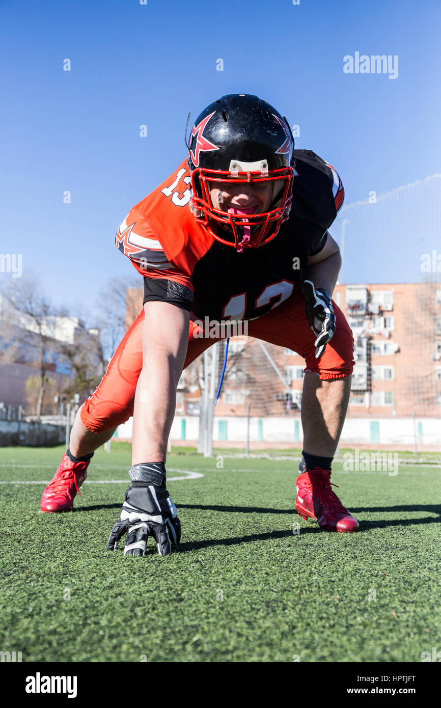 American football player with helmet on sports field Stock Photo Alamy