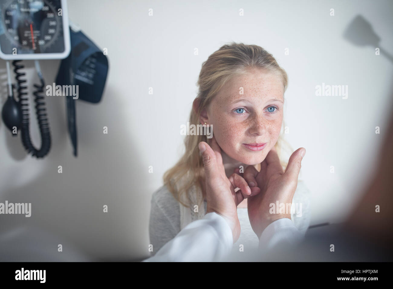 Doctor checking girl's lymph nodes Stock Photo