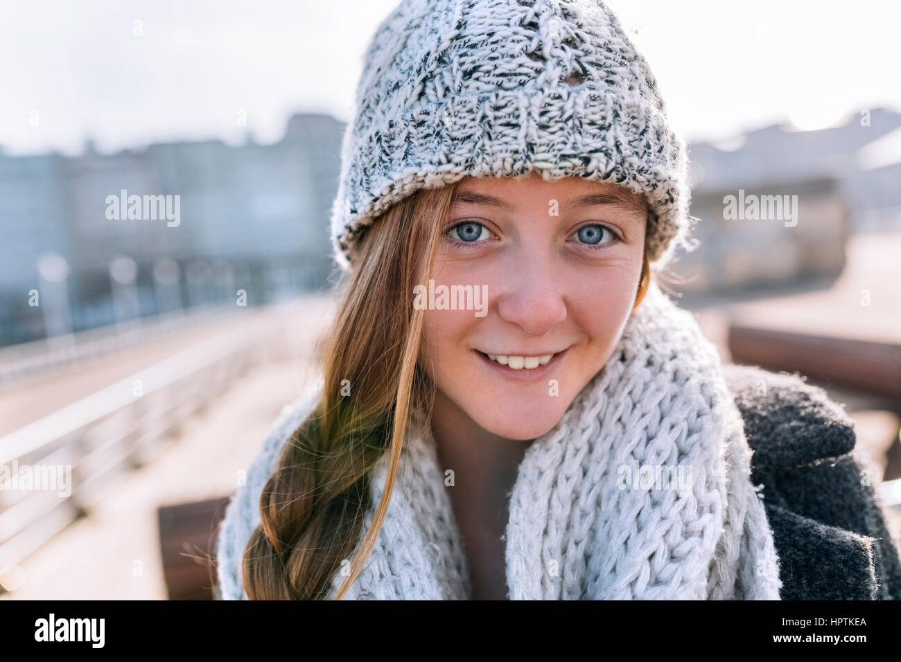 Portrait of smiling teenage girl wearing woolly hat and scarf Stock ...
