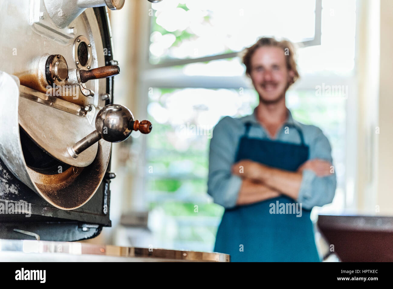 Machine and man in coffee roastery Stock Photo Alamy