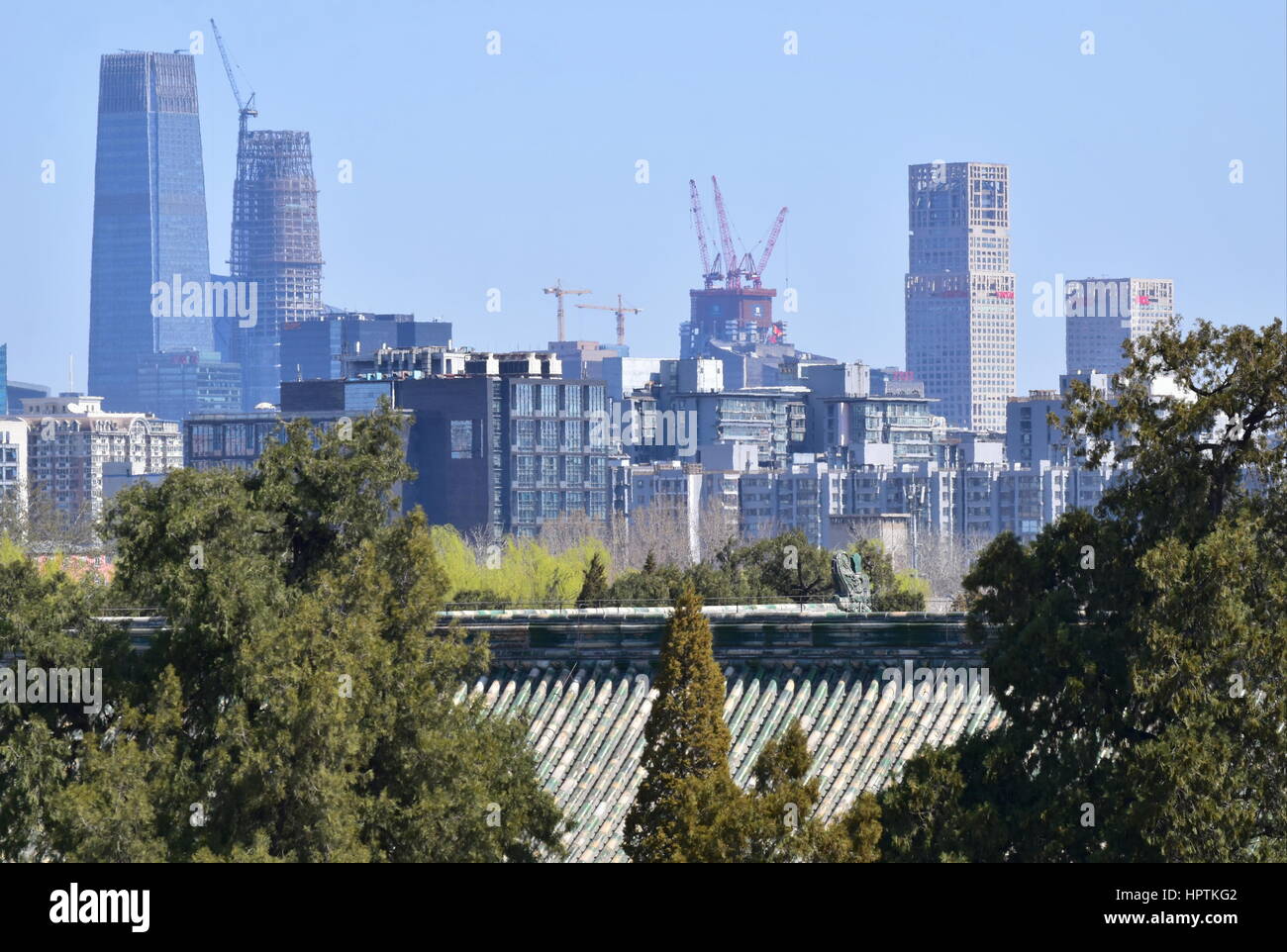 Beijing clean sky city modern skyline under construction contrasted with the traditional Chinese rooftops of the Temple of Heaven Stock Photo