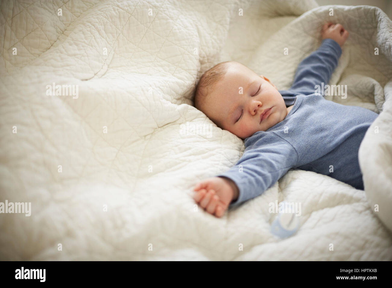 Baby sleeping in bed Stock Photo - Alamy