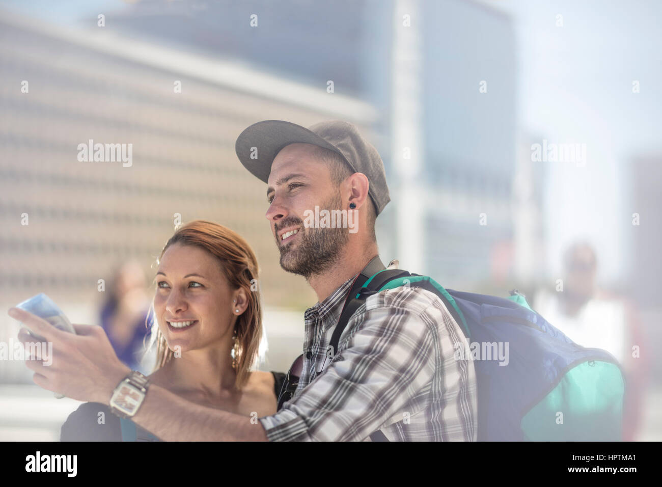 Backpacker couple searching for directions in the city Stock Photo Alamy
