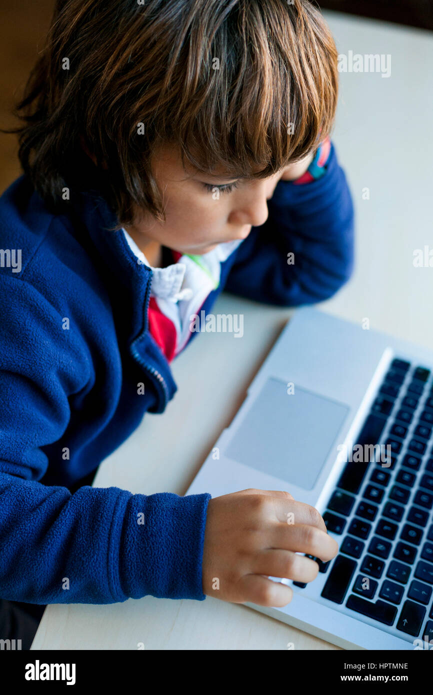 Little boy using laptop Stock Photo - Alamy