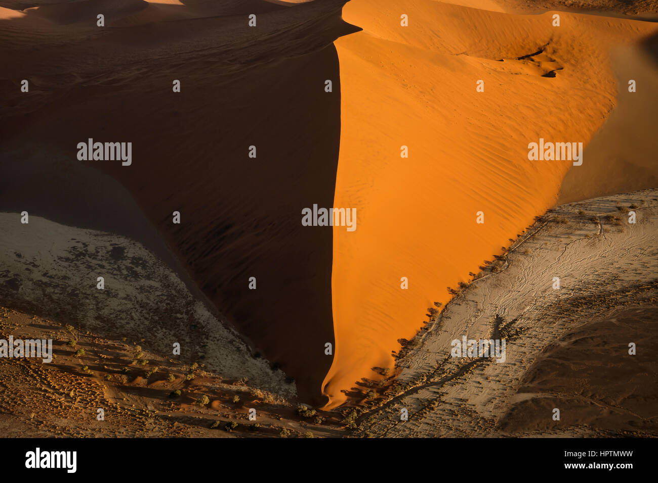 Aerial photograph of a red sand dune of the Namib desert at Namib-Naukluft National Park, Namibia, Africa, during sunrise. Stock Photo