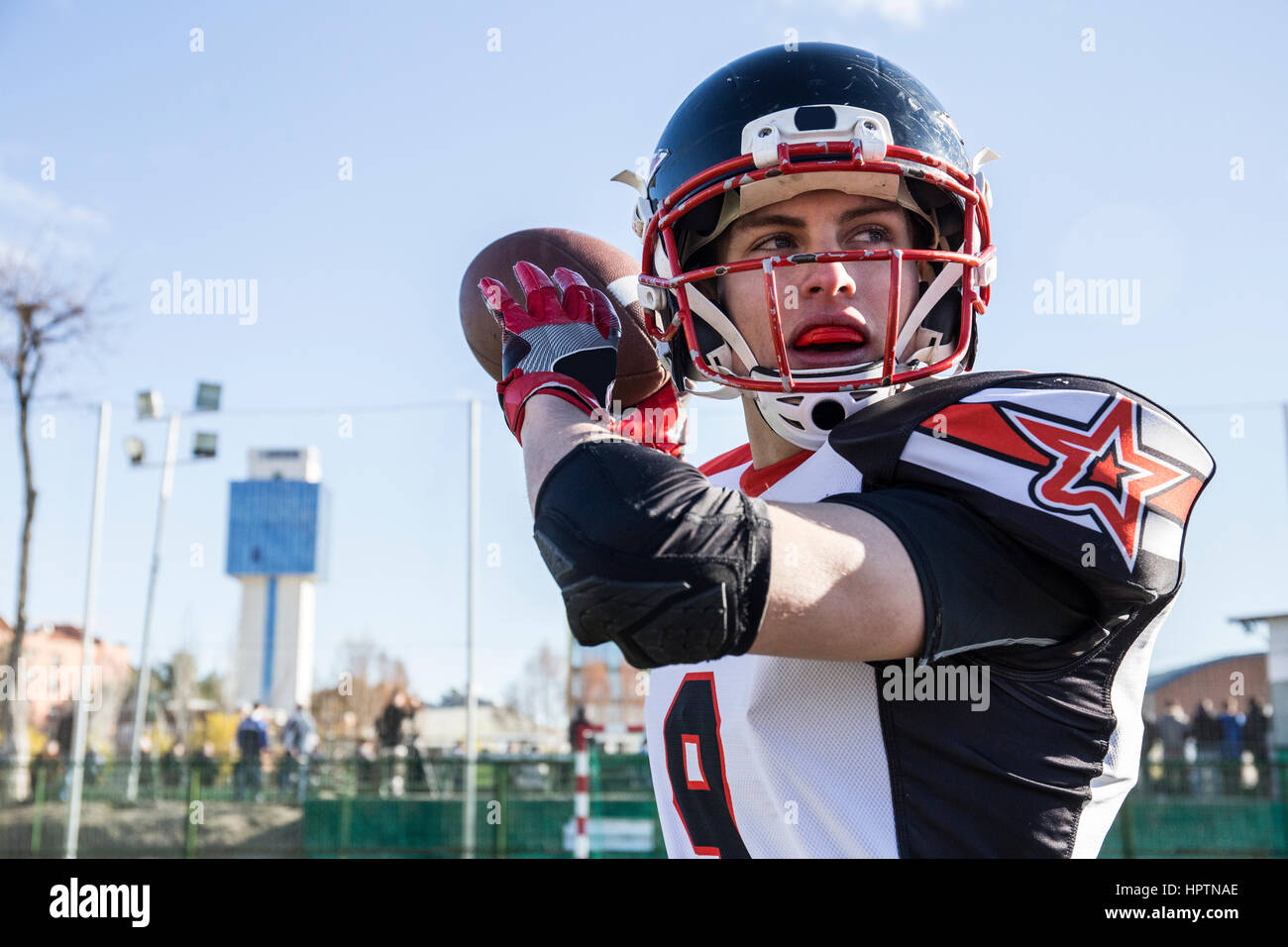 American football player throwing the ball during a match Stock Photo
