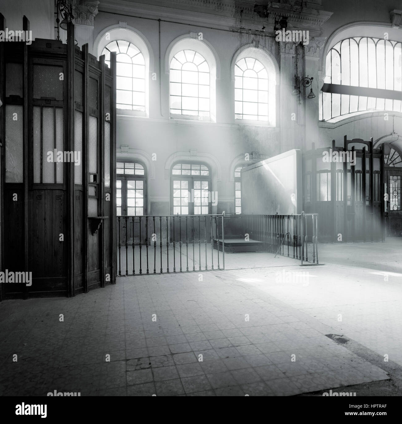 Black and white image of a railway station lobby with a light effect through the windows Stock Photo