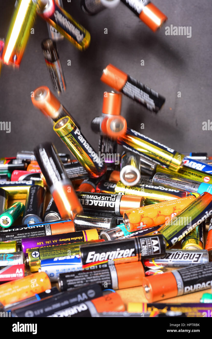 throwing old AA and AAA batteries into recycling box Stock Photo