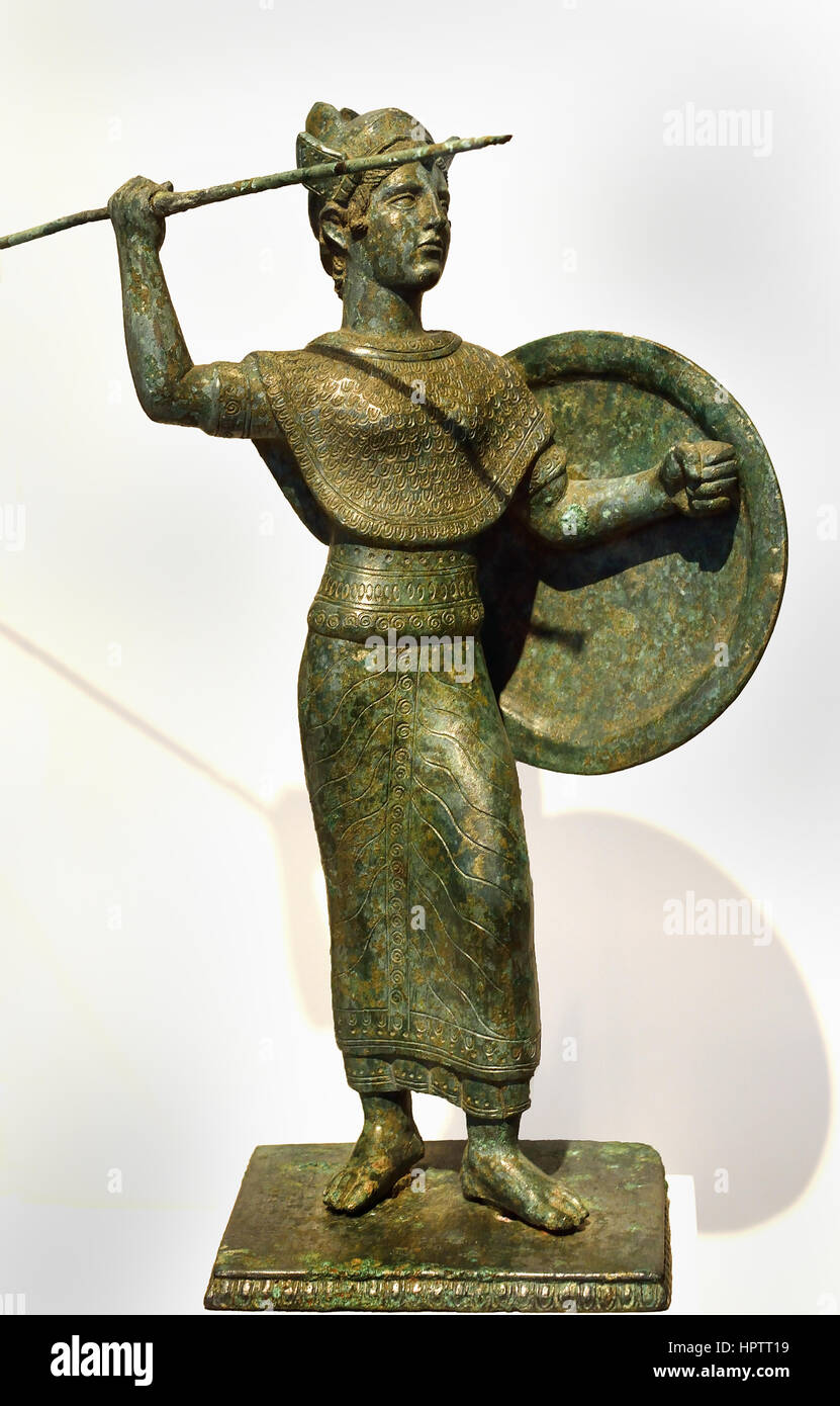 Etruscan goddess Menvra 400 BC  modelled on Greek figures of Pallas Athena, or Palladion, with raised spear (or lance) and shield and wearing the aegis. The helmet, similar in form to the Attic helmet worn on Greek copies of the Athena Parthenos is shown with the cheek flaps raised. Unusually, the goddess is barefoot, lacking the usual sandals . Etruria, Tuscany, Italy, Stock Photo