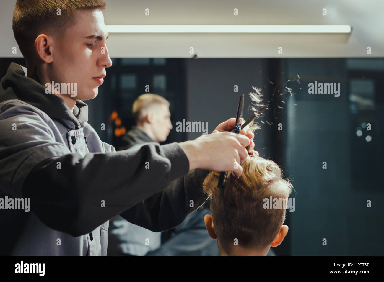 Little Boy Getting Haircut By Barber. Barbershop Theme Stock Photo