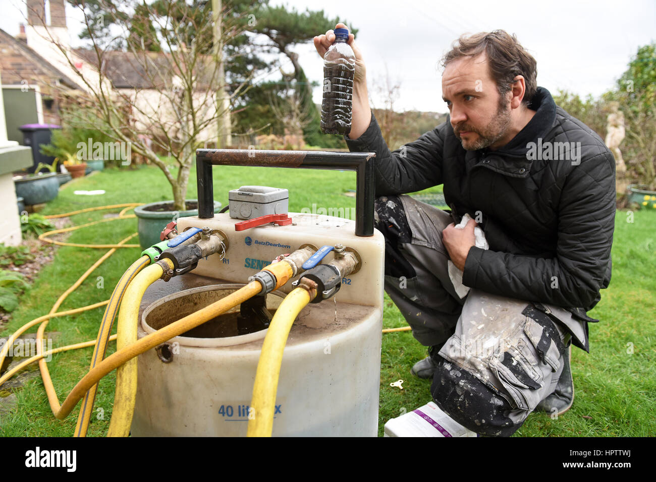 Heating engineer plumber power flushing a domestic central heating system Stock Photo