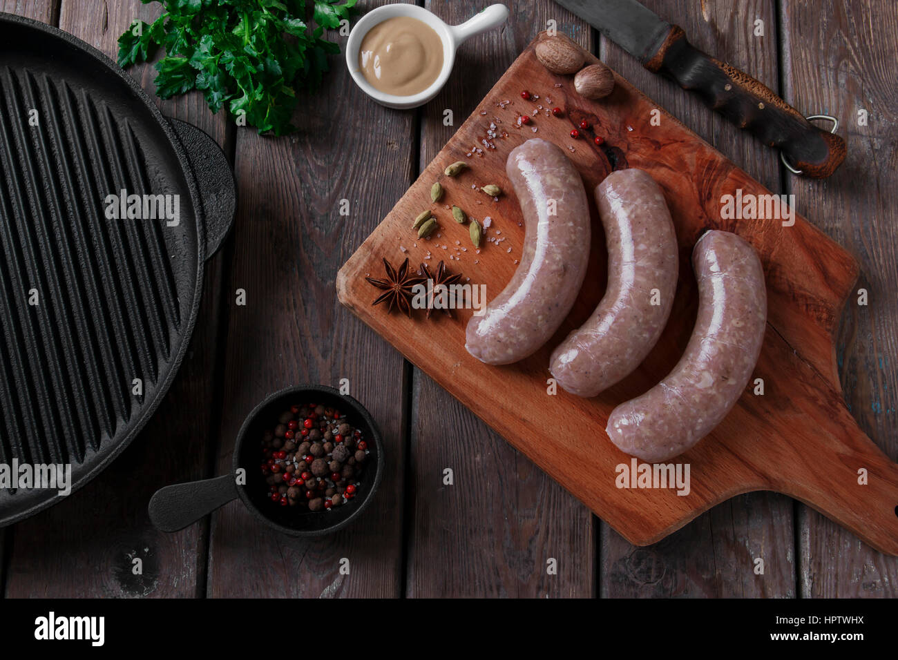 homemade raw sausage with spices on the board Stock Photo