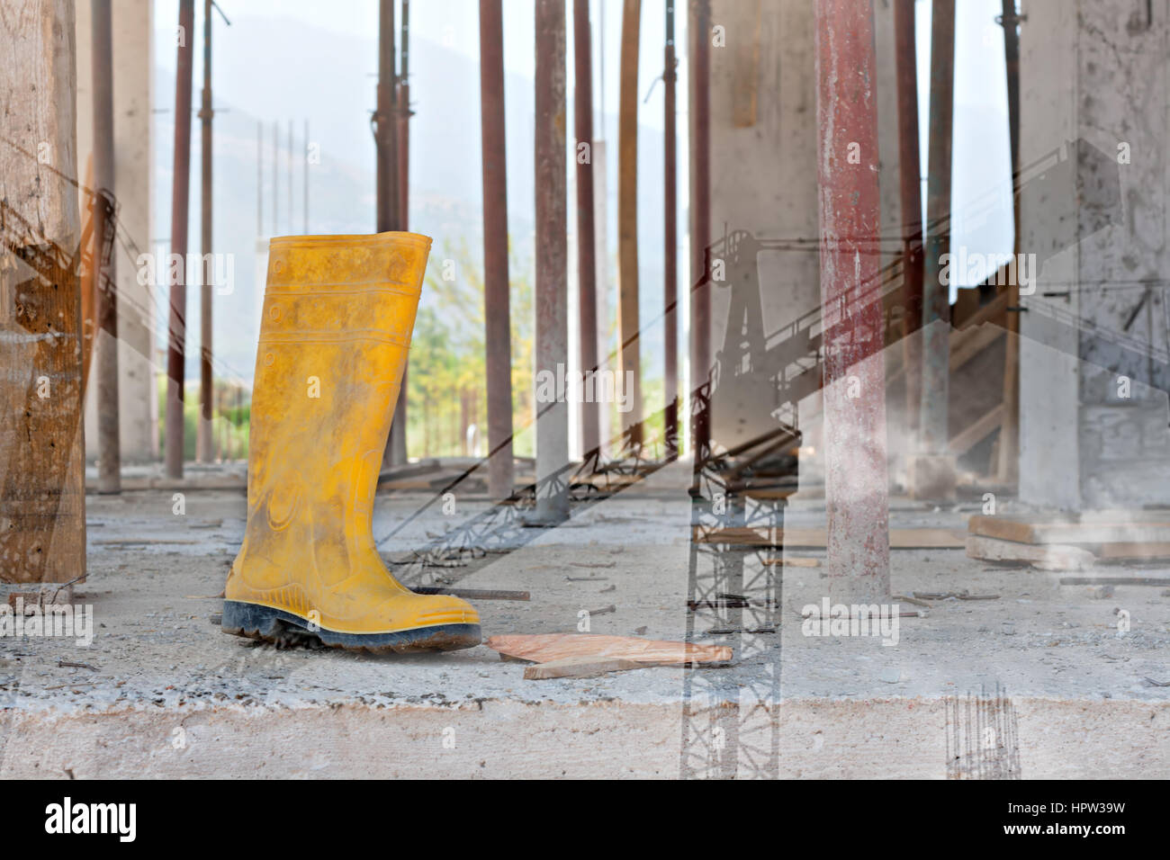 double exposure of a steel toed work boot and construction tower cranes Stock Photo