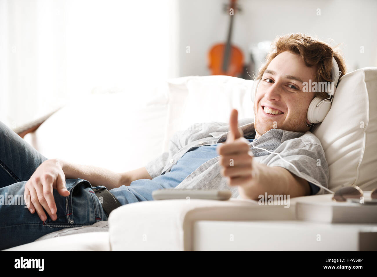 Young man thumbs up home hi-res stock photography and images - Alamy