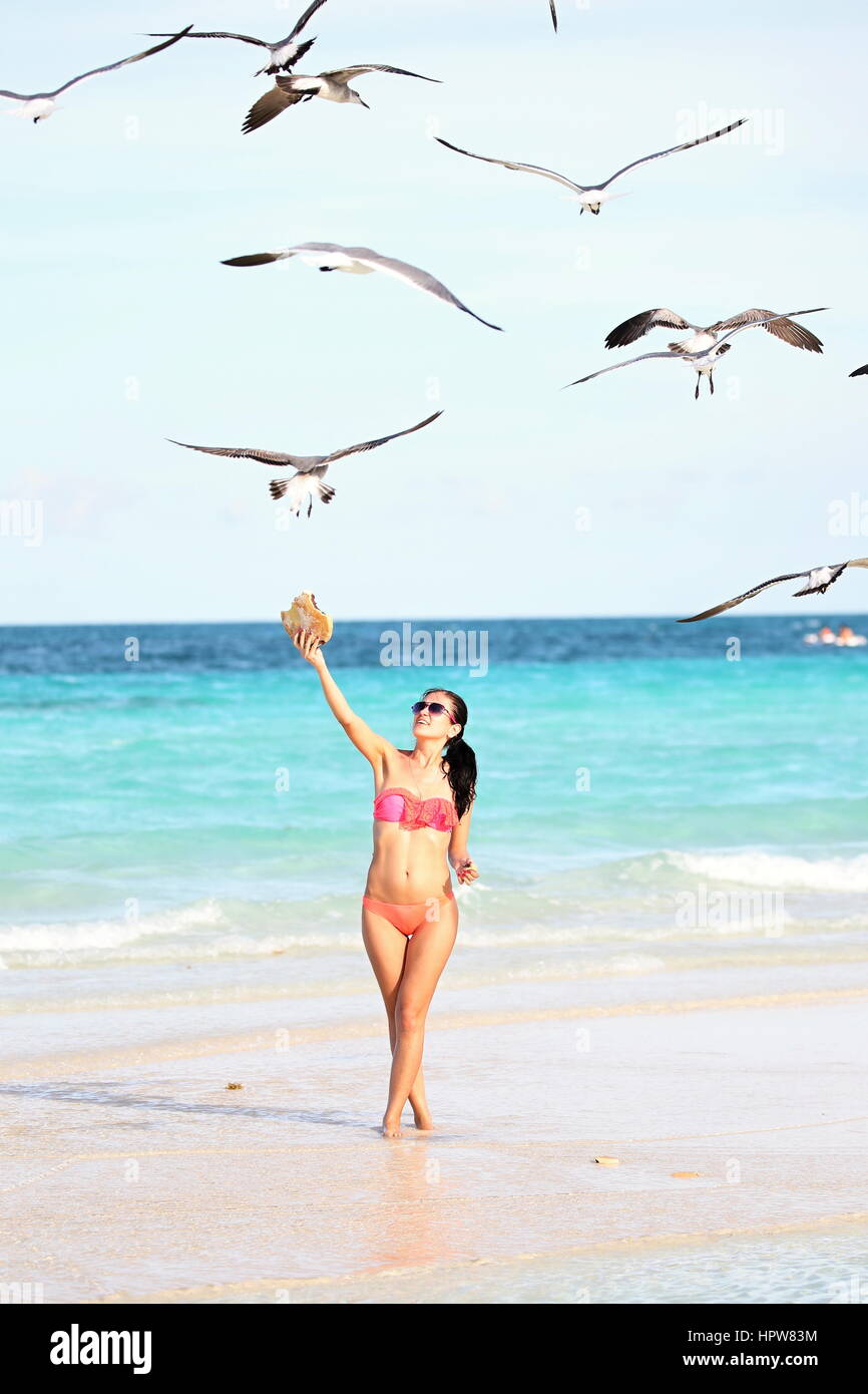 Cayo Coco Beach, woman, birds, feeding Stock Photo