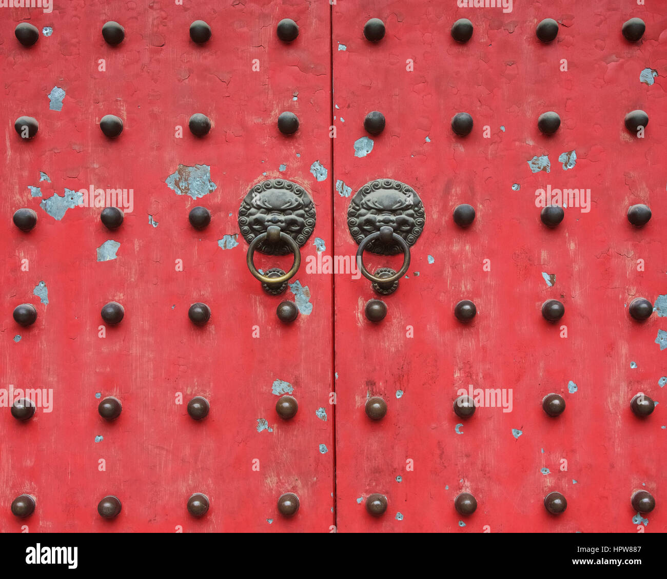 Studded red door to Jade Buddha temple in Shanghai Stock Photo