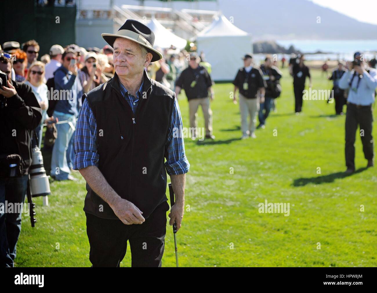 Actor and comedian Bill Murray wearing a matching black hat and sweater vest in action during the AT&T Pebble Beach National Pro-Am golf tournament February 9, 2011 in Monterey, California. Stock Photo