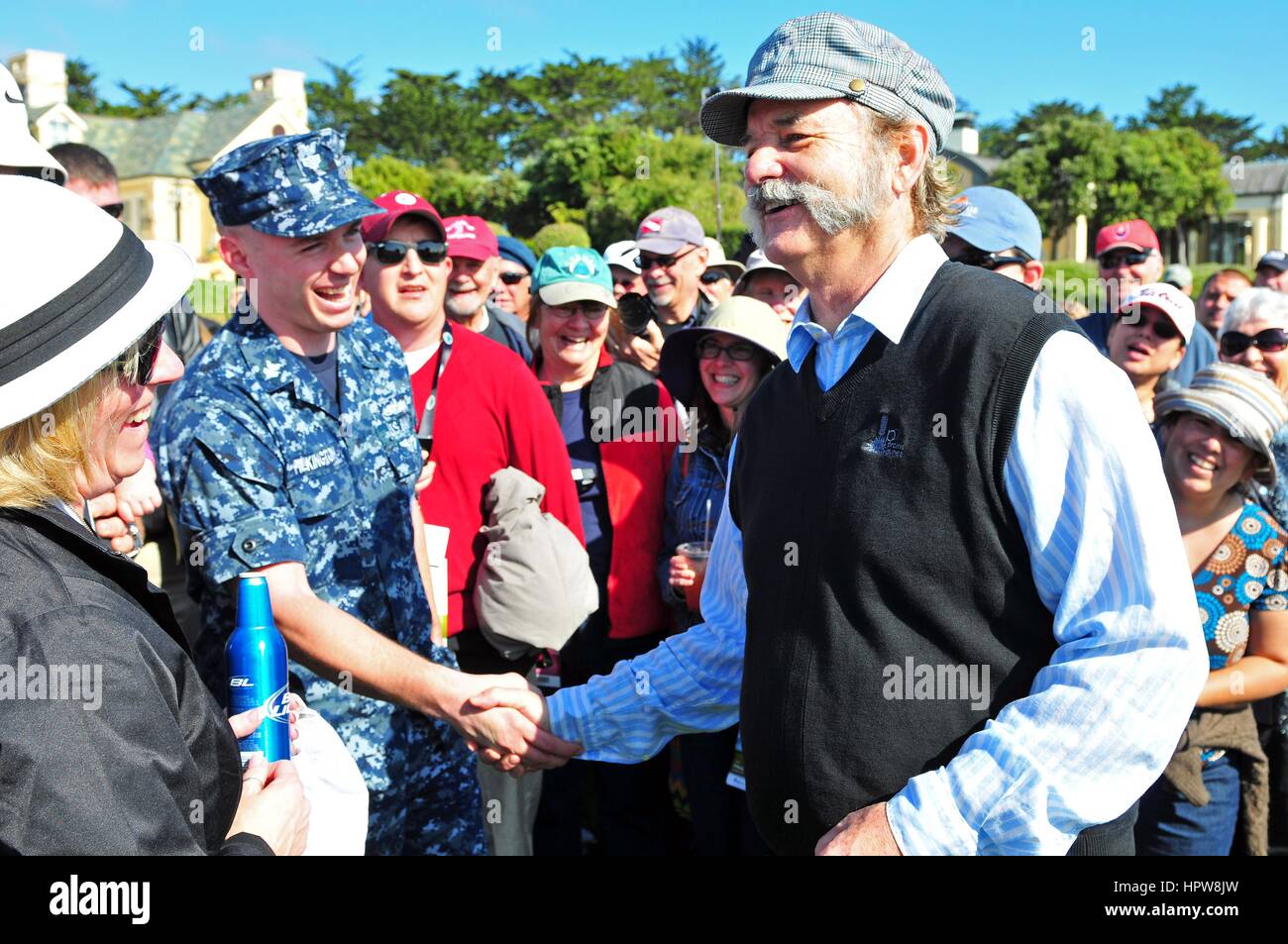 Actor and comedian Bill Murray sporting a tweed cap and Mutton Chops mustache greets the crowd during the AT&T Pebble Beach National Pro-Am golf tournament February 6, 2013 in Monterey, California. Stock Photo