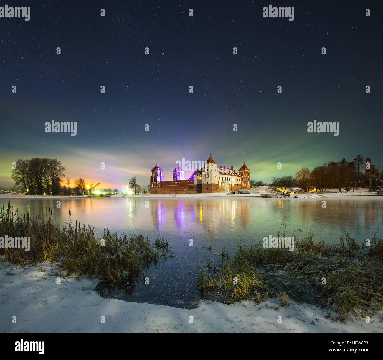 Winter night near the castle. Frozen lake. Stock Photo