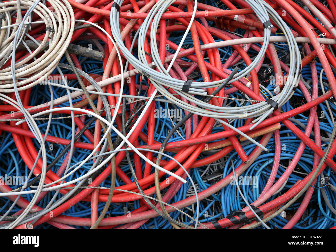old high-voltage electric cables and other power cords in a special waste collection centre Stock Photo