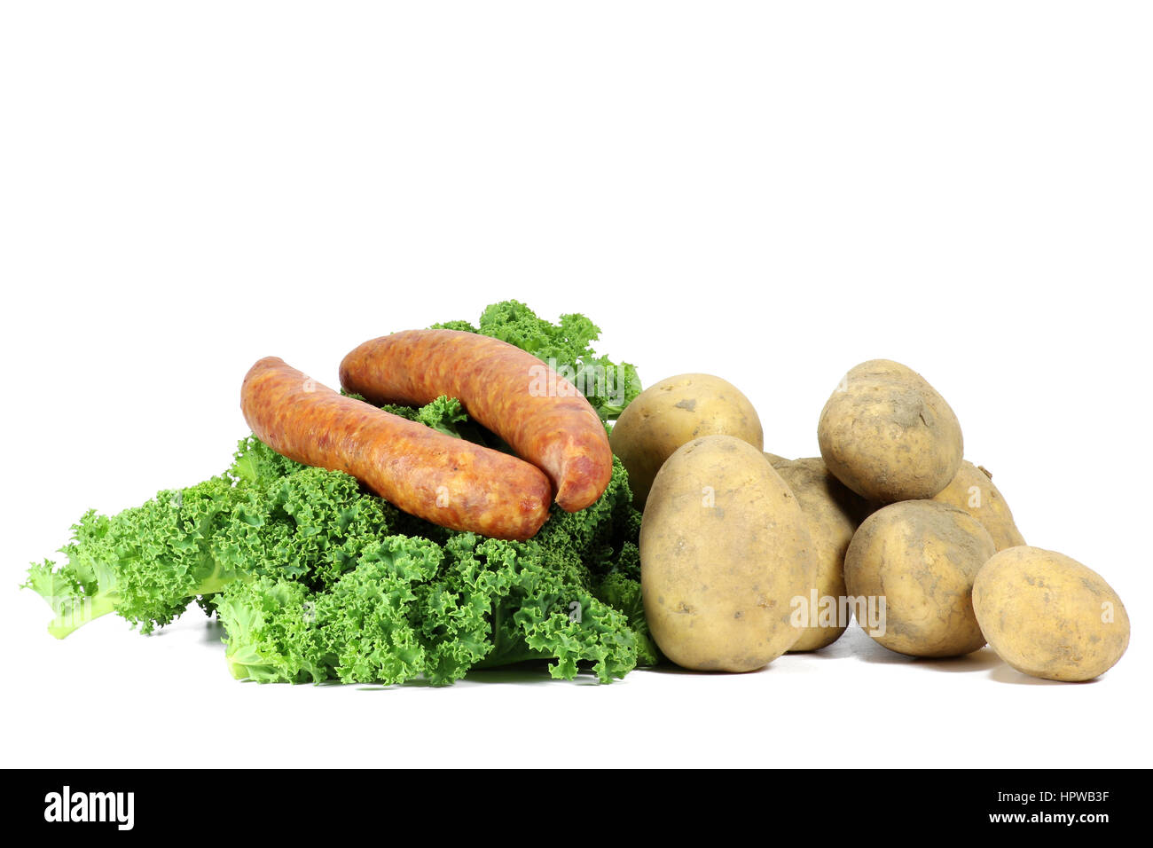 ingredients of a traditional German curly kale meal isolated on white