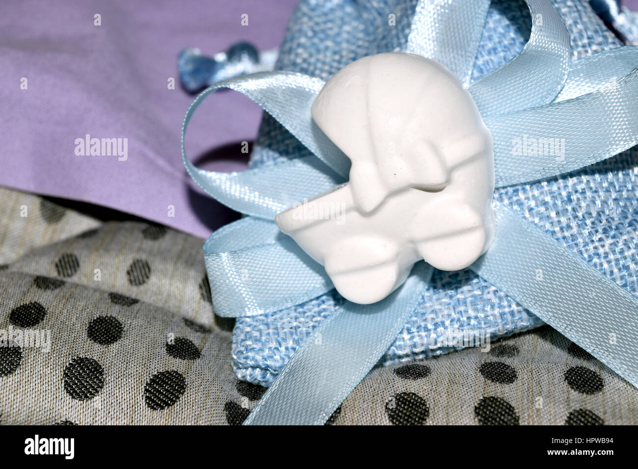 blue bag with confetti and decoration of a cradle shape Stock Photo