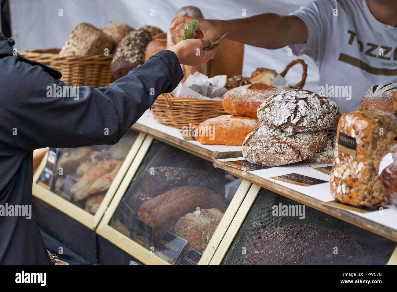 Bakery market stall transaction with lovely German bread - Nelson food market Stock Photo