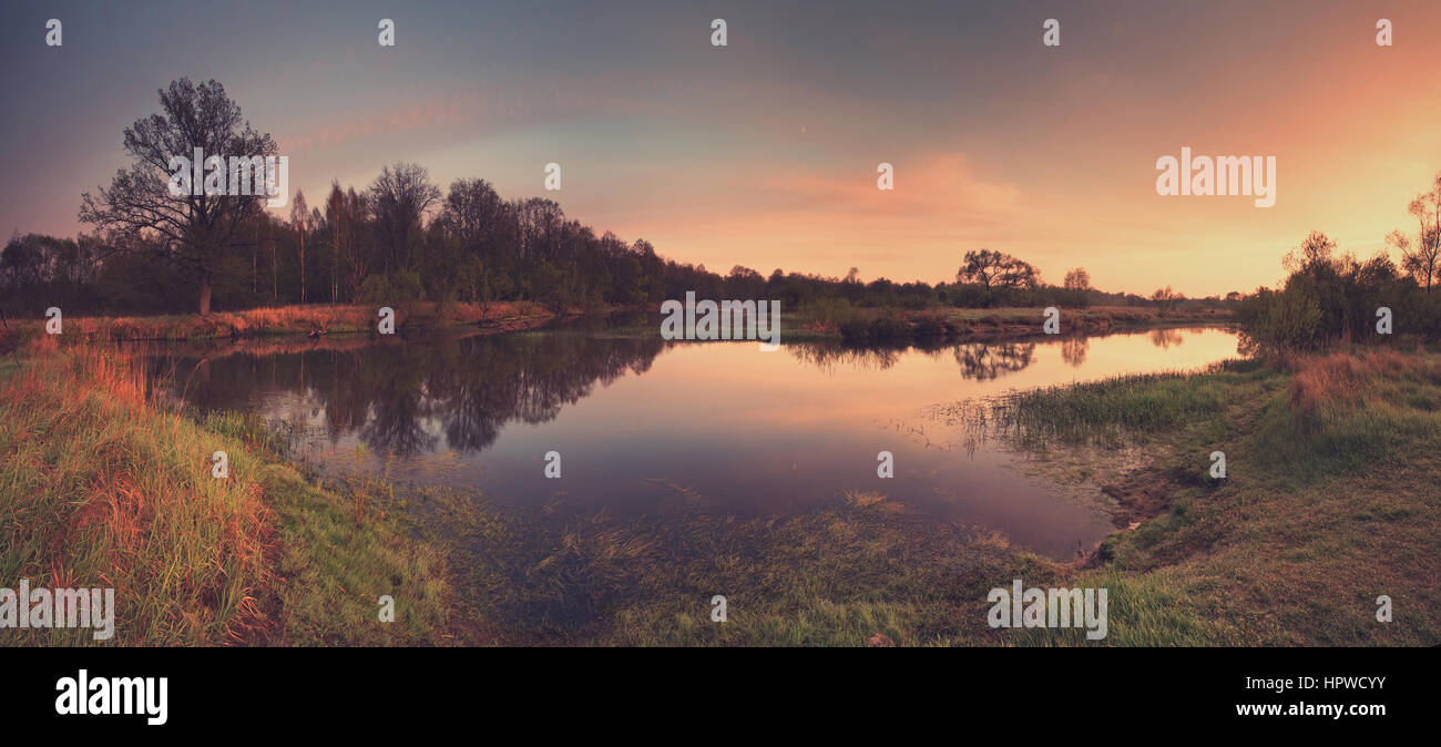 Colorful sunrise above misty lake brown and blue colours Stock Photo