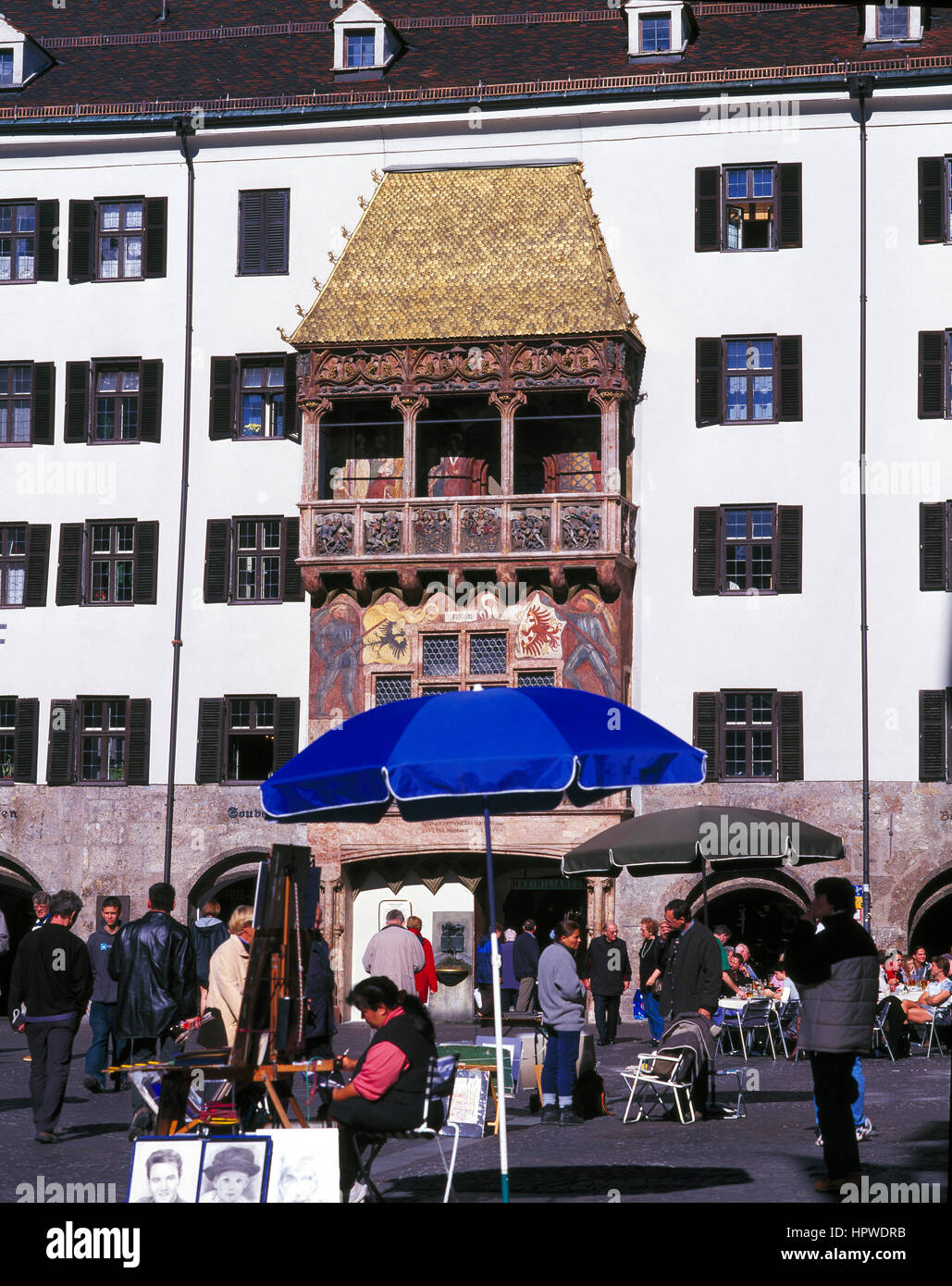 Tourists at a pavement cafe by the famous Golden Roof, Innsbruck, Austria. Stock Photo
