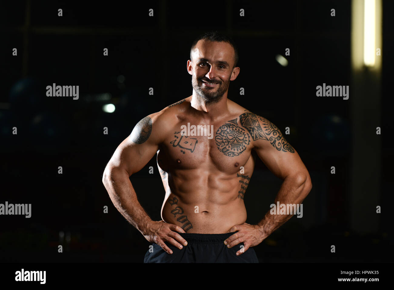 Black and White Photo of a Tattooed Man in Tank Top Sitting in a Gym · Free  Stock Photo, image size:1300x957