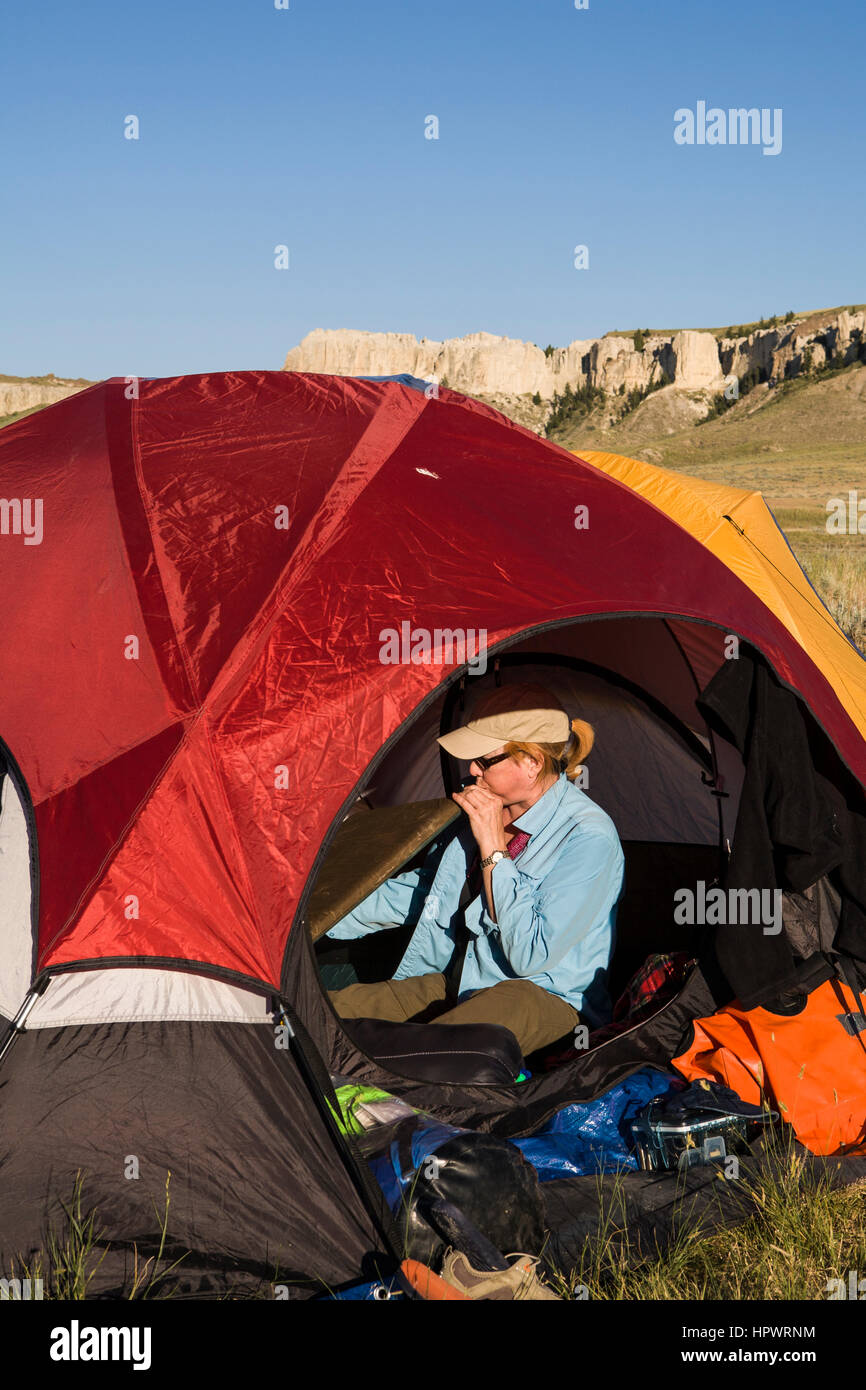 A camper blows up her sleeping pad at HoleintheWall Campground, Upper Missouri River Breaks