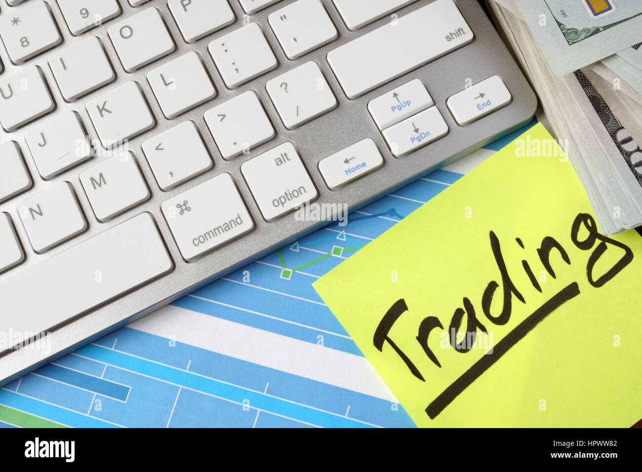 Paper with word Trading, cash, keyboard and business charts. Stock Photo