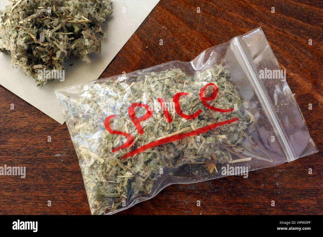 Plastic bag of marijuana on a table. Stock Photo