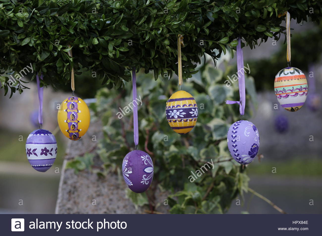 Handpainted Easter eggs hang from a fountain in a village in Handpainted Easter eggs hang from a fountain in a village in