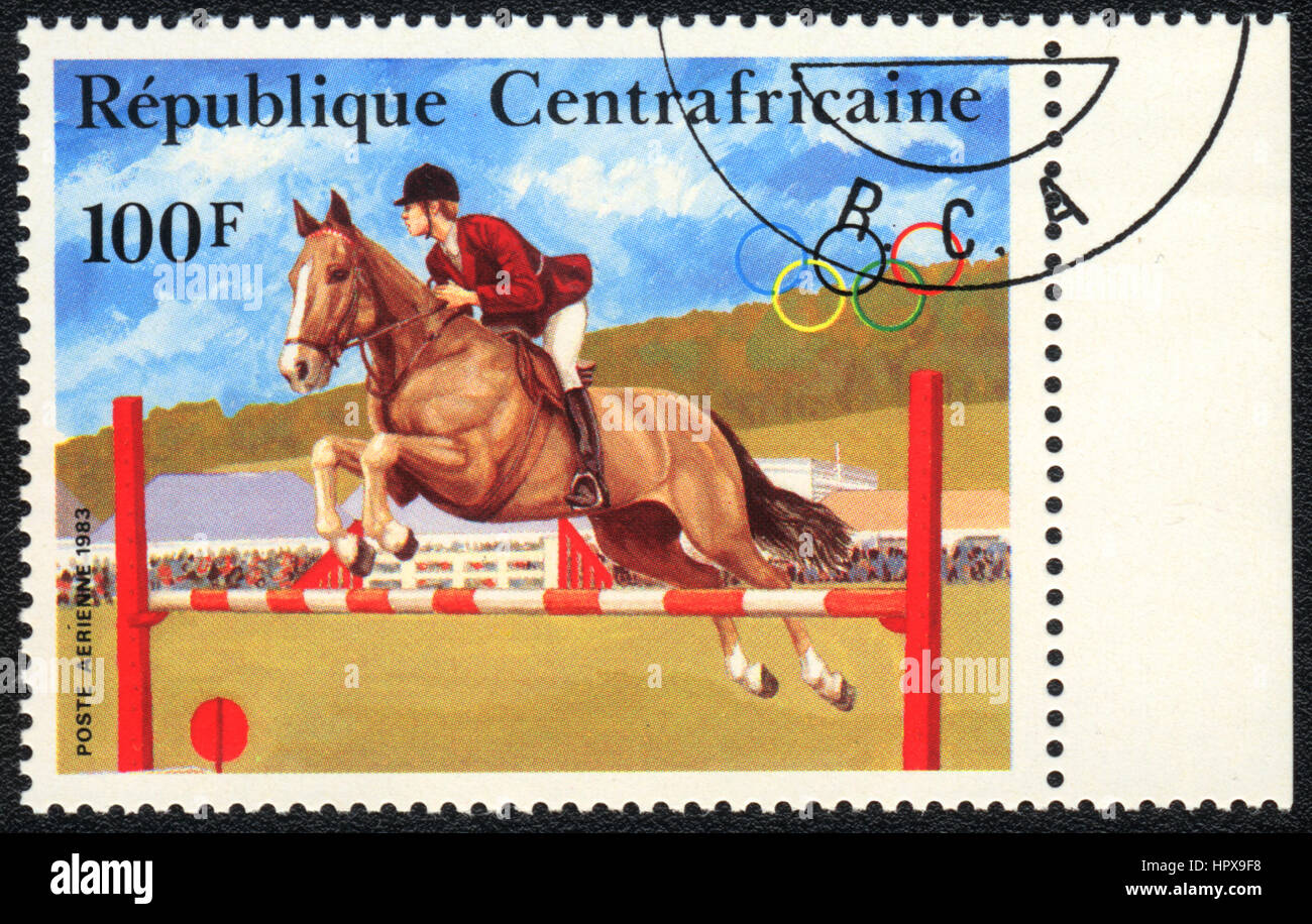 A postage stamp printed in  Central African Republic  shows a  Show jumping, from series Equestrianism, circa 1983 Stock Photo