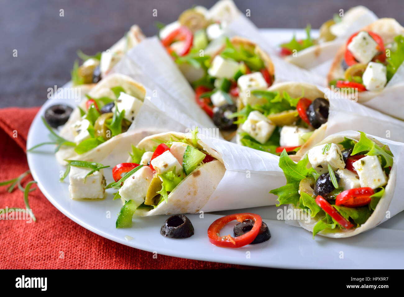 Mini tortillas stuffed with Greek farmers salad with feta cheese and