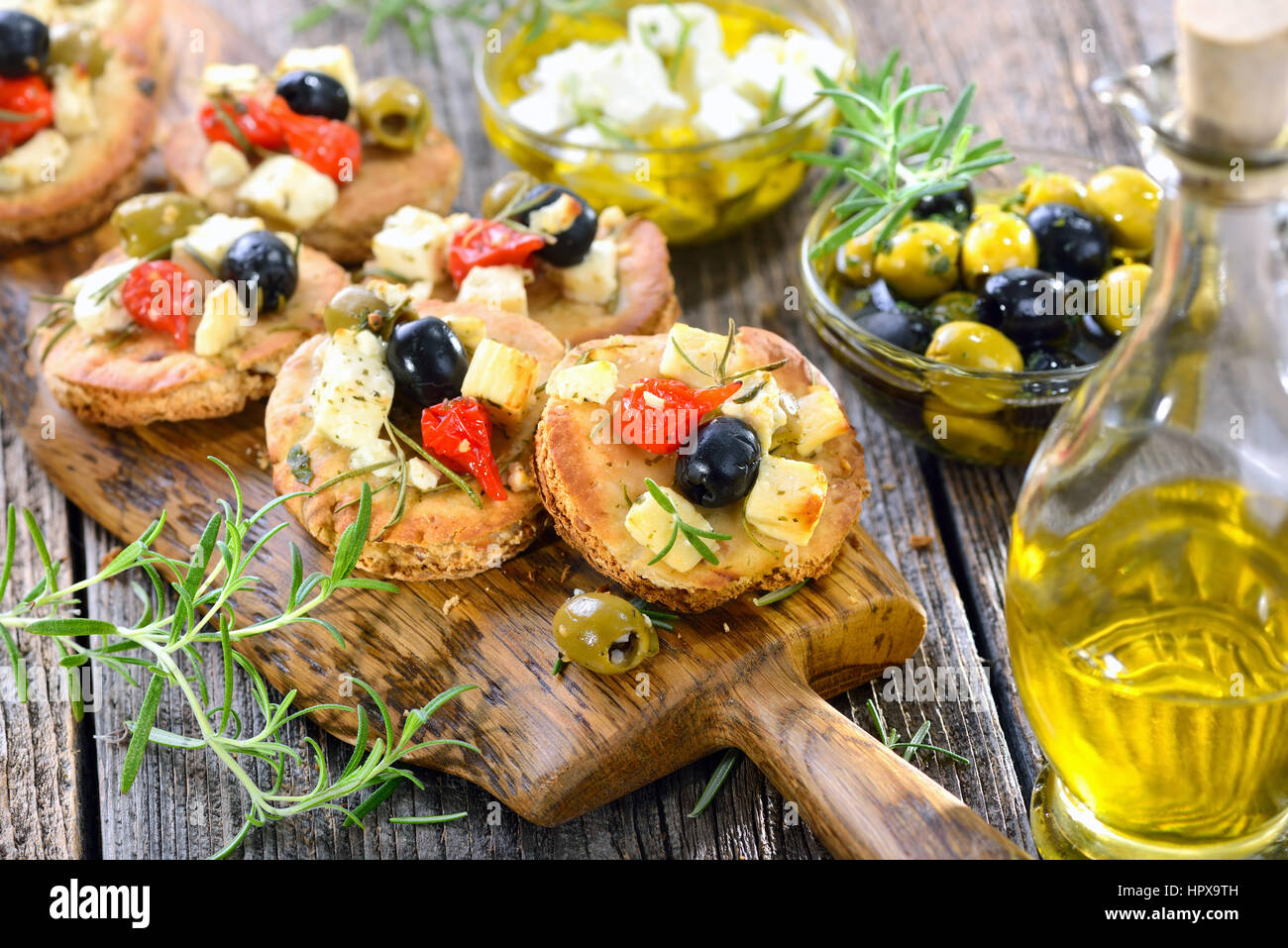 Warm Greek appetizers Crispy baked pita bread with feta cheese, olives