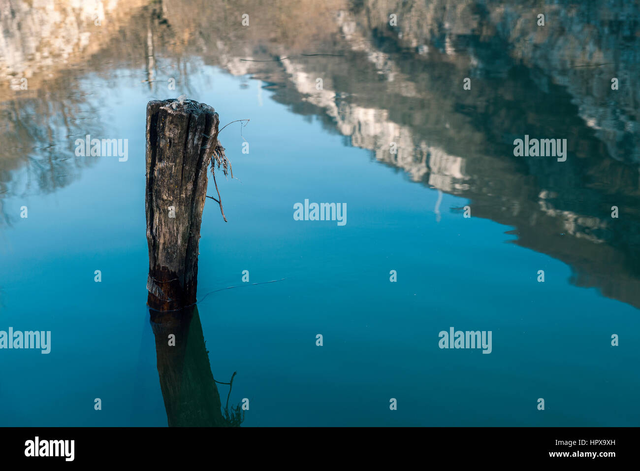 Reflection stone walls in the water of the lake Stock Photo