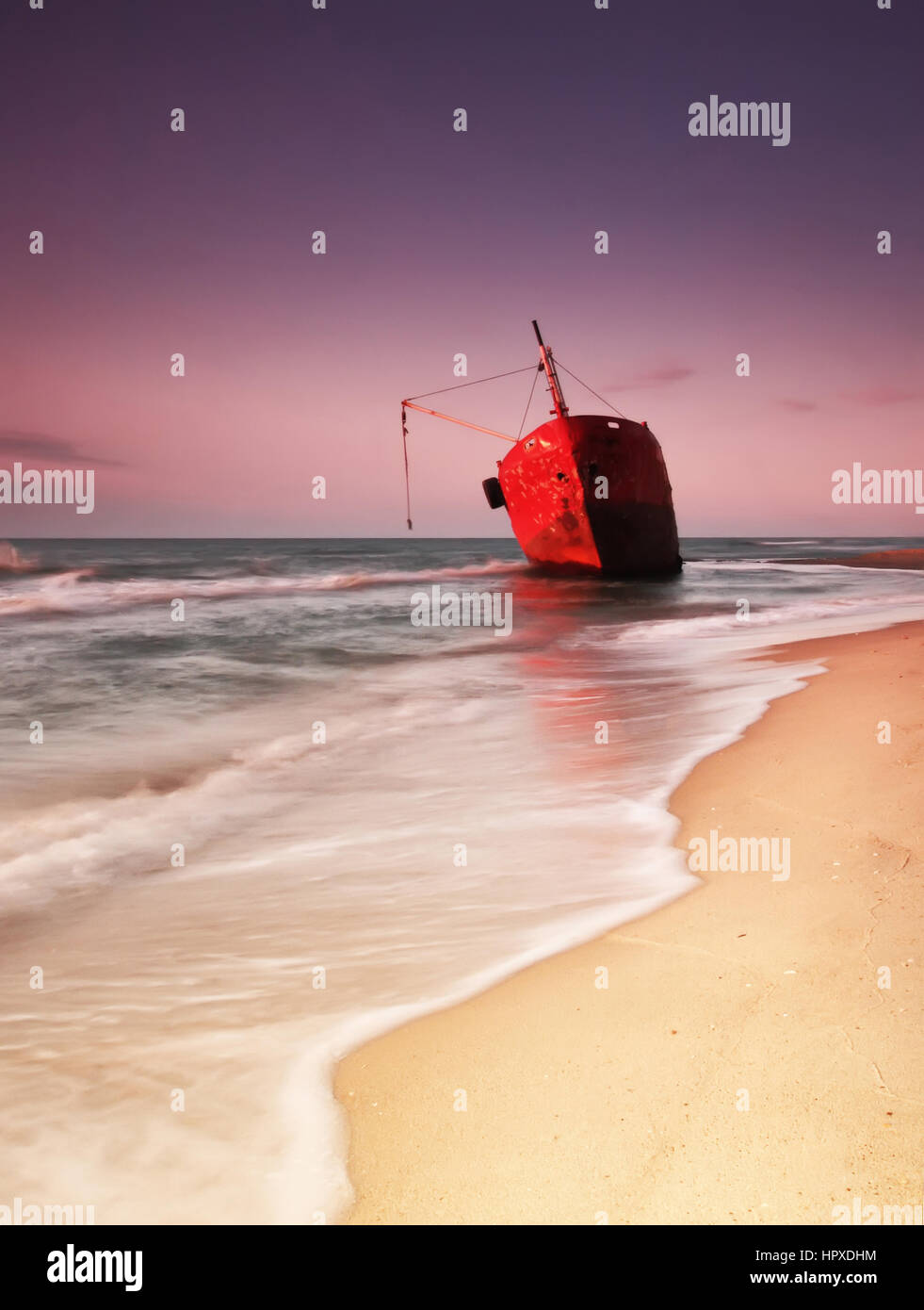 red ship after wreck on the coast with smooth water Stock Photo