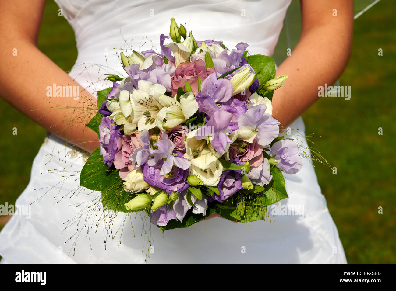 bride holding wedding bouquet with roses Stock Photo - Alamy